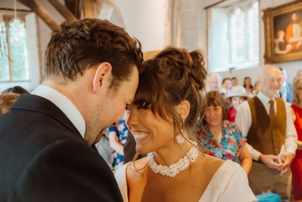 A romantic moment between newlyweds sharing a tender moment during their wedding reception.