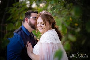Romantic wedding couple shares intimate moments in a garden setting with natural greenery in the background, North Carolina rustic wedding.