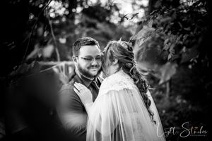 Black and white art edited wedding photo showing intimate moments between couples during an outdoor celebration.