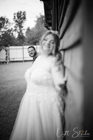 A series of black and white wedding photos showing elegant dress details and romantic outdoor moments.