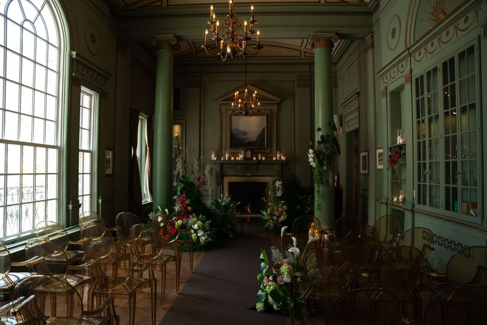 Elegant palace interior with ornate chandeliers, tall windows, and mirrored walls reflects classical European architecture.