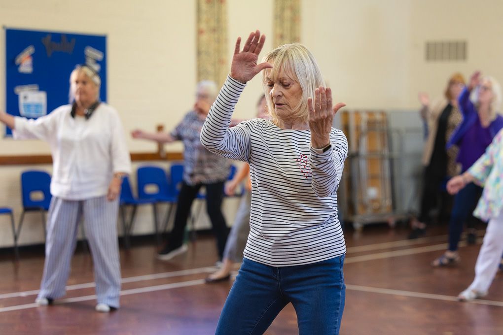 Seniors participate in a group line dancing class in Letchworth.