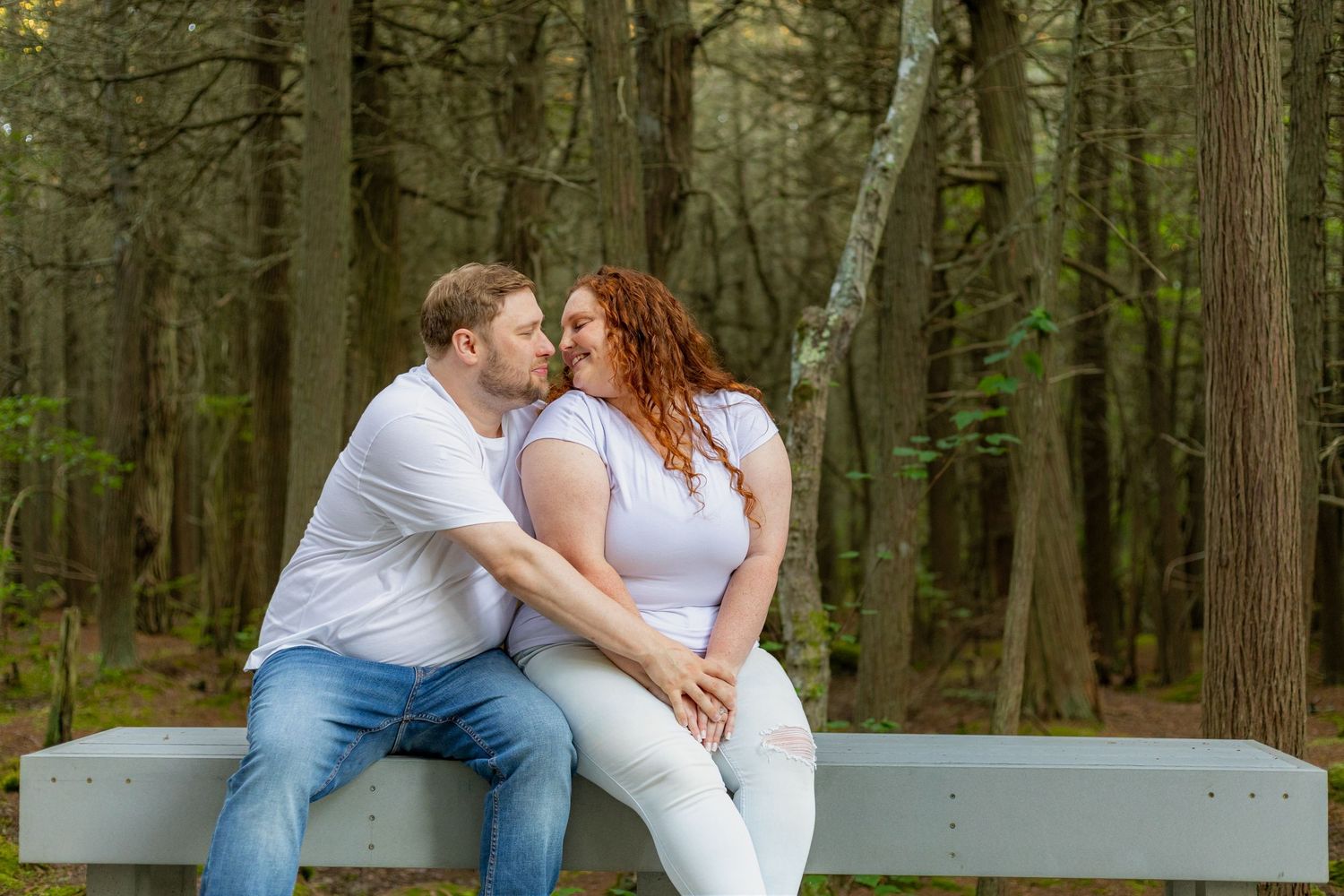 A romantic engagement photo session in a golden marsh field during sunset.