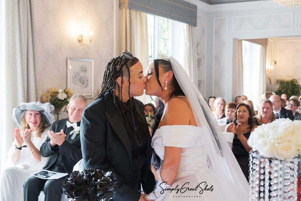 Southcrest Manor Hotel wedding photographer captures the moment a marriage is sealed with a kiss for Holly and Tanysha.