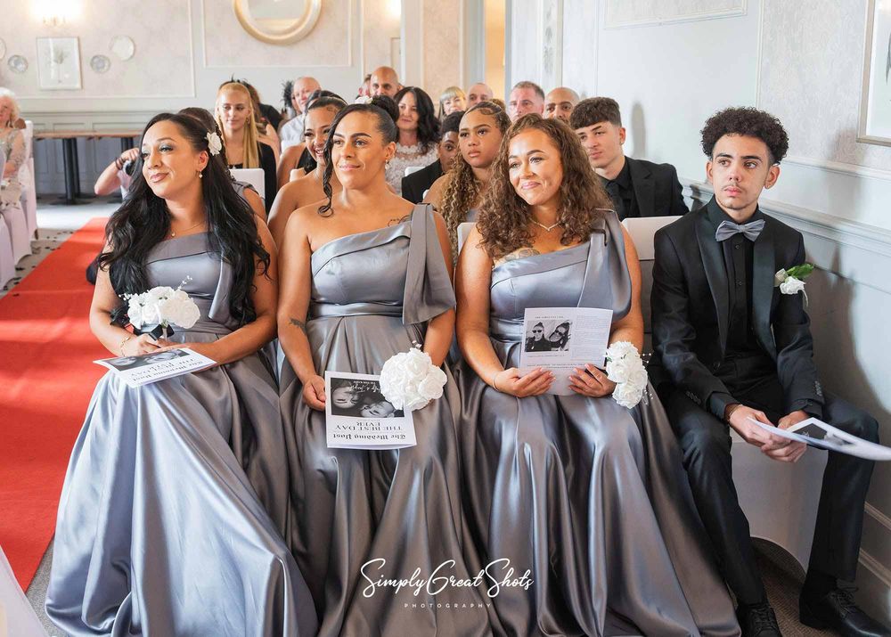 Southcrest Manor wedding photographer captures bridesmaids look lovingly towards the happy married couple.