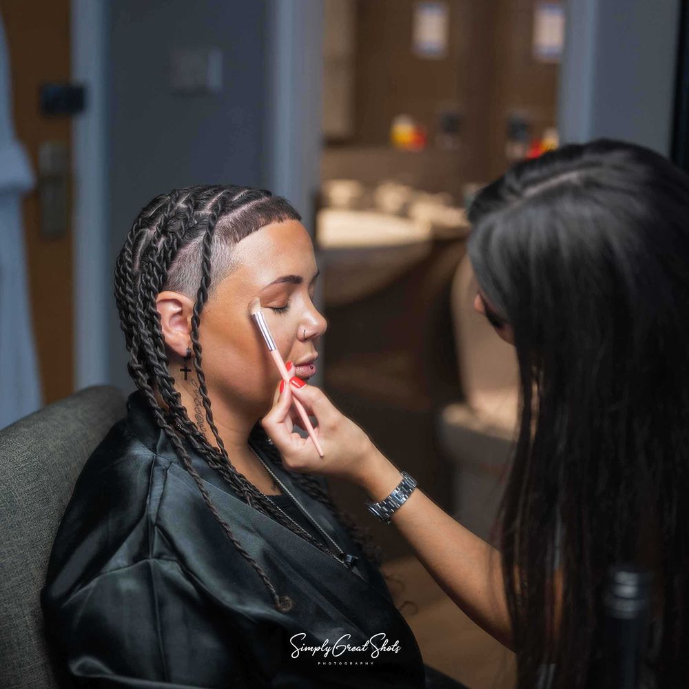 A makeup artiste applies makeup to a LGBTQ+ bride.