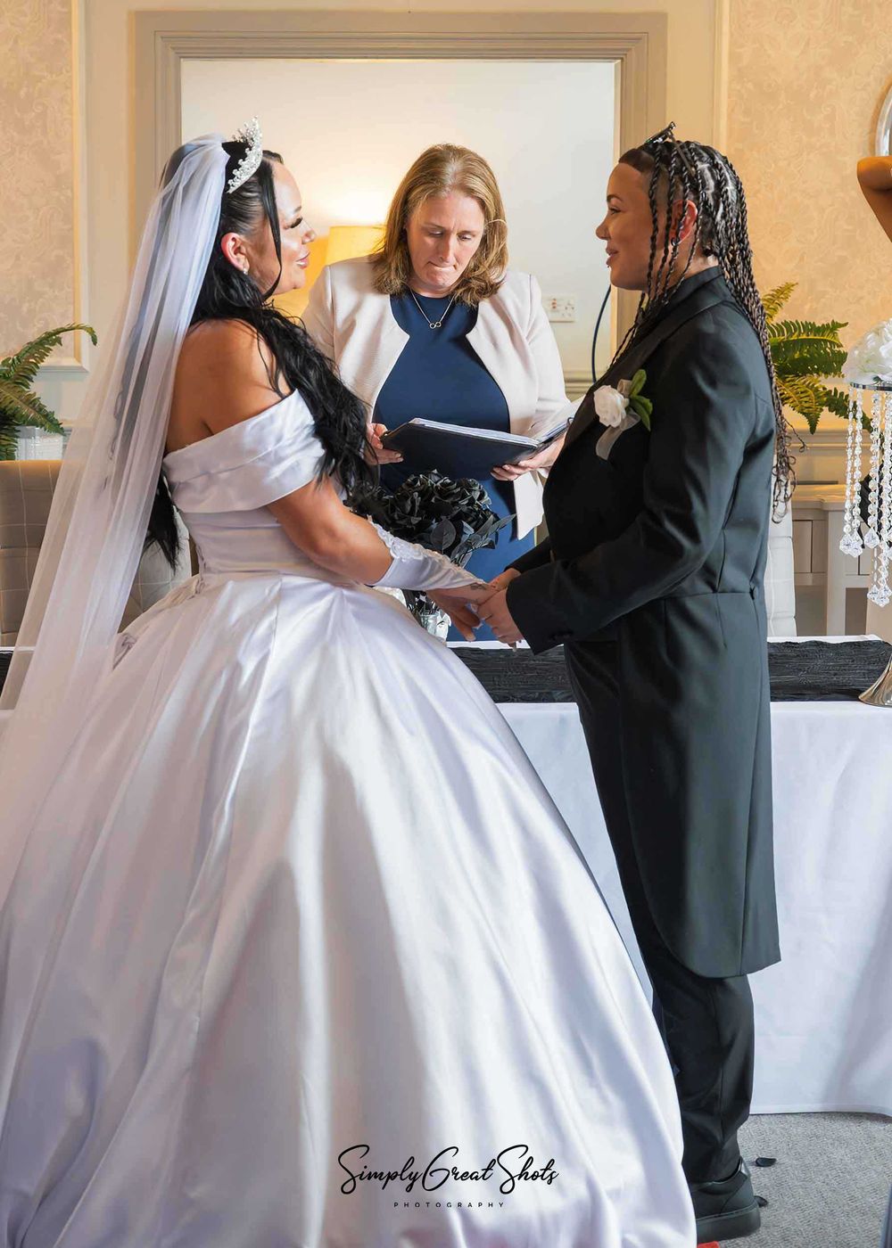 An LGBTQ+ couple at their wedding ceremony at Southcrest Manor Hotel in Redditch.