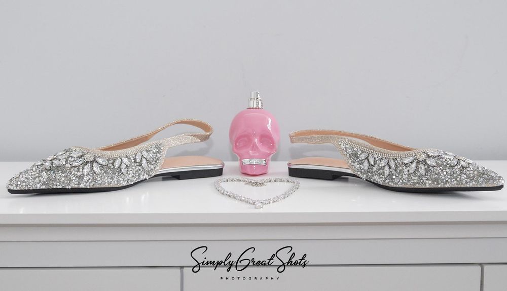 Bridal shoes, perfume by Police and a diamond brides necklace captured by a wedding photographer at South Crest Manor Hotel