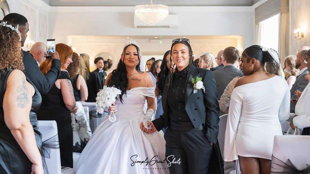 A married couple walk down the aisle at Southcrest Manor Hotel.