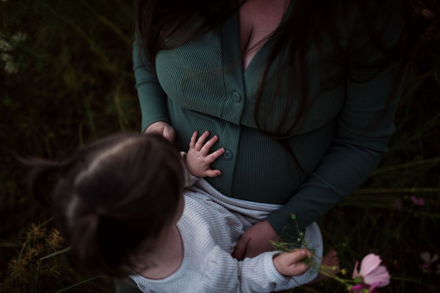 A romantic engagement photo shoot in a wooded forest setting with soft natural lighting.