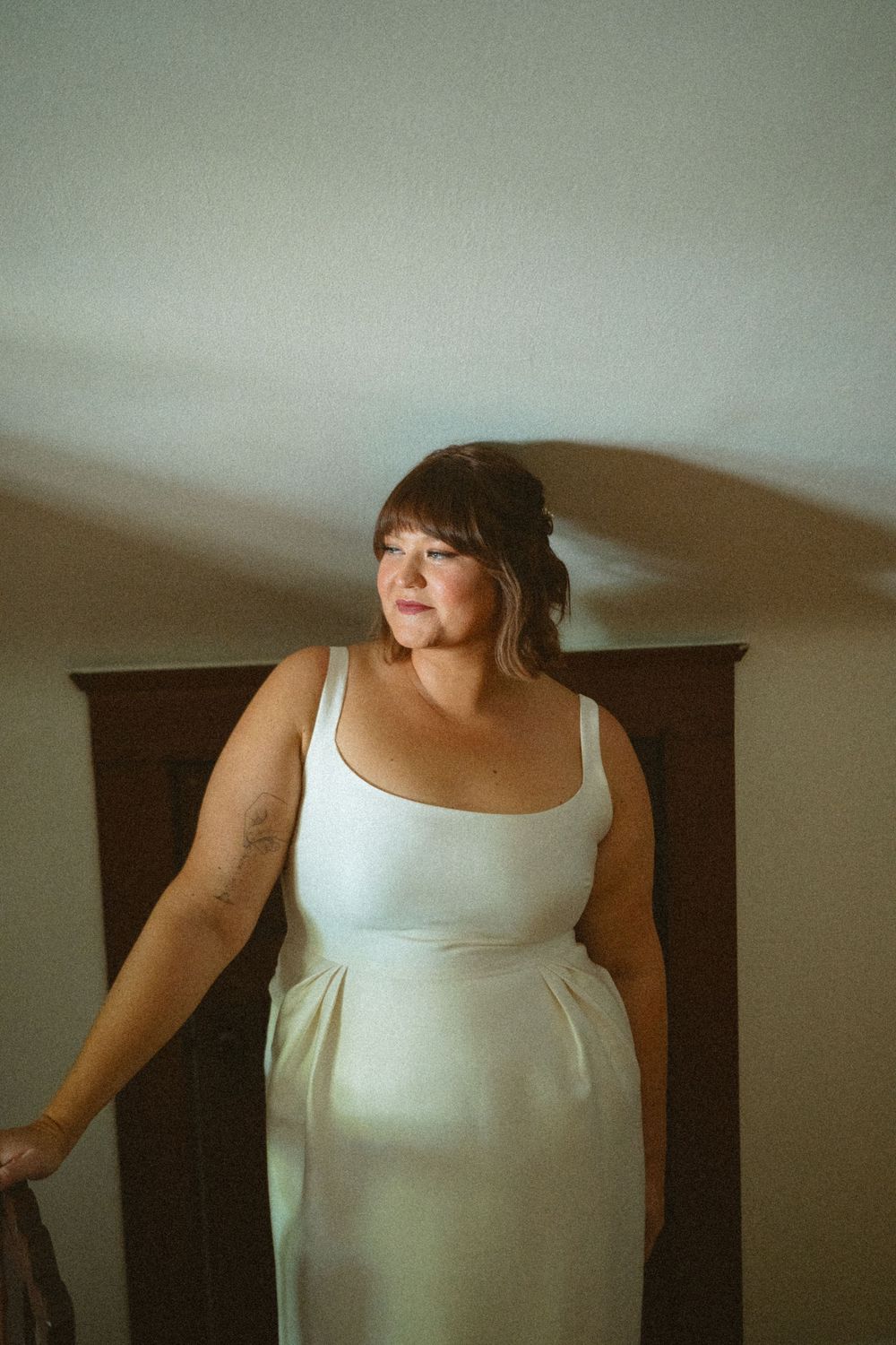 A sequence of photos showing a person in a white tank top against a dark background.
