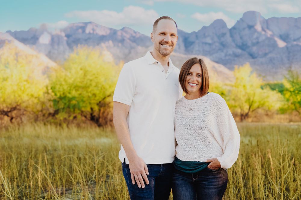 Couple's portrait session with dramatic mountain peaks in the background.