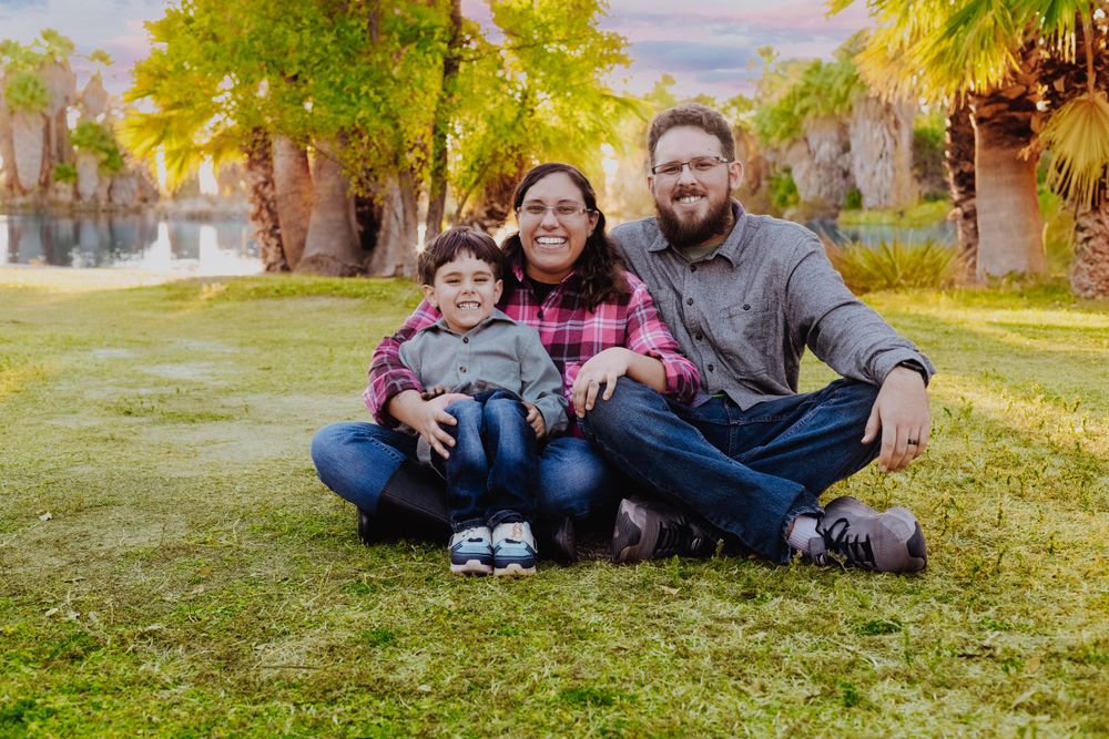 A casual outdoor fall photo session in a park with golden foliage.