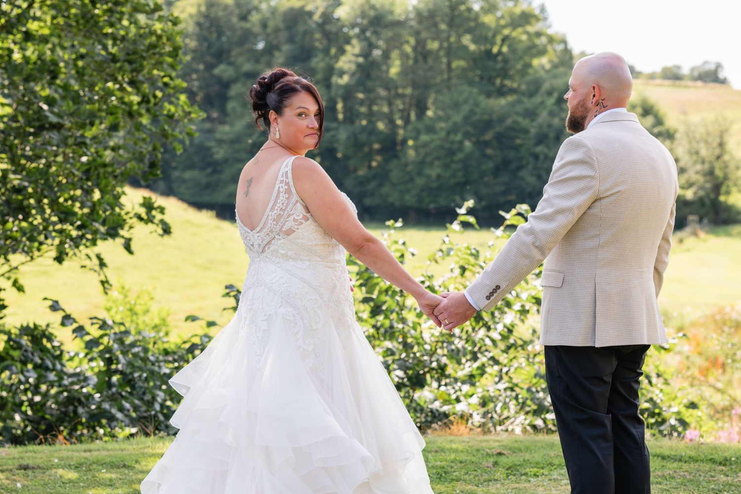 Romantic wedding portraits captured in a lush summer garden setting.