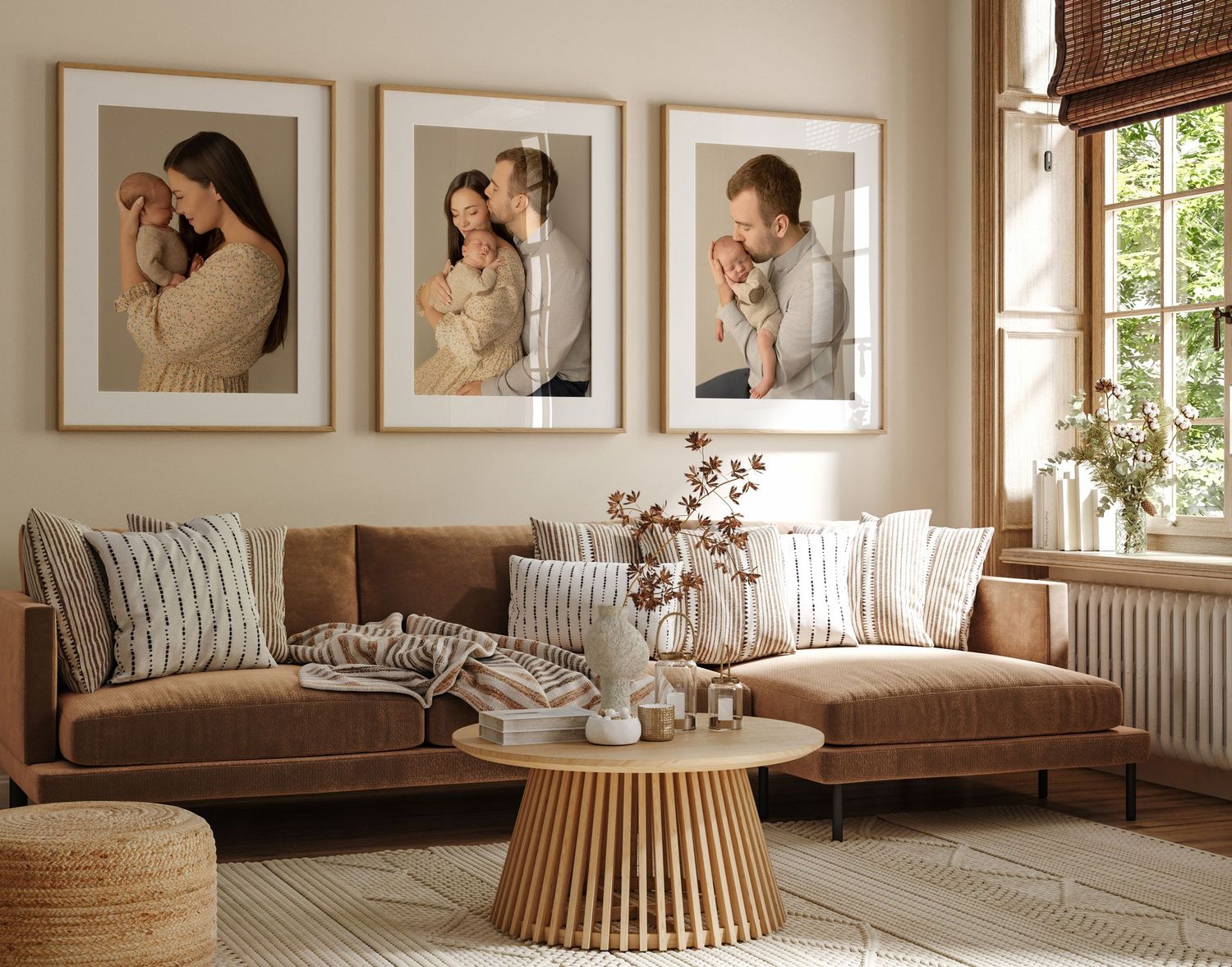 A cozy living room with large portrait photos above a brown sofa, featuring a modern rattan coffee table and natural decor.
