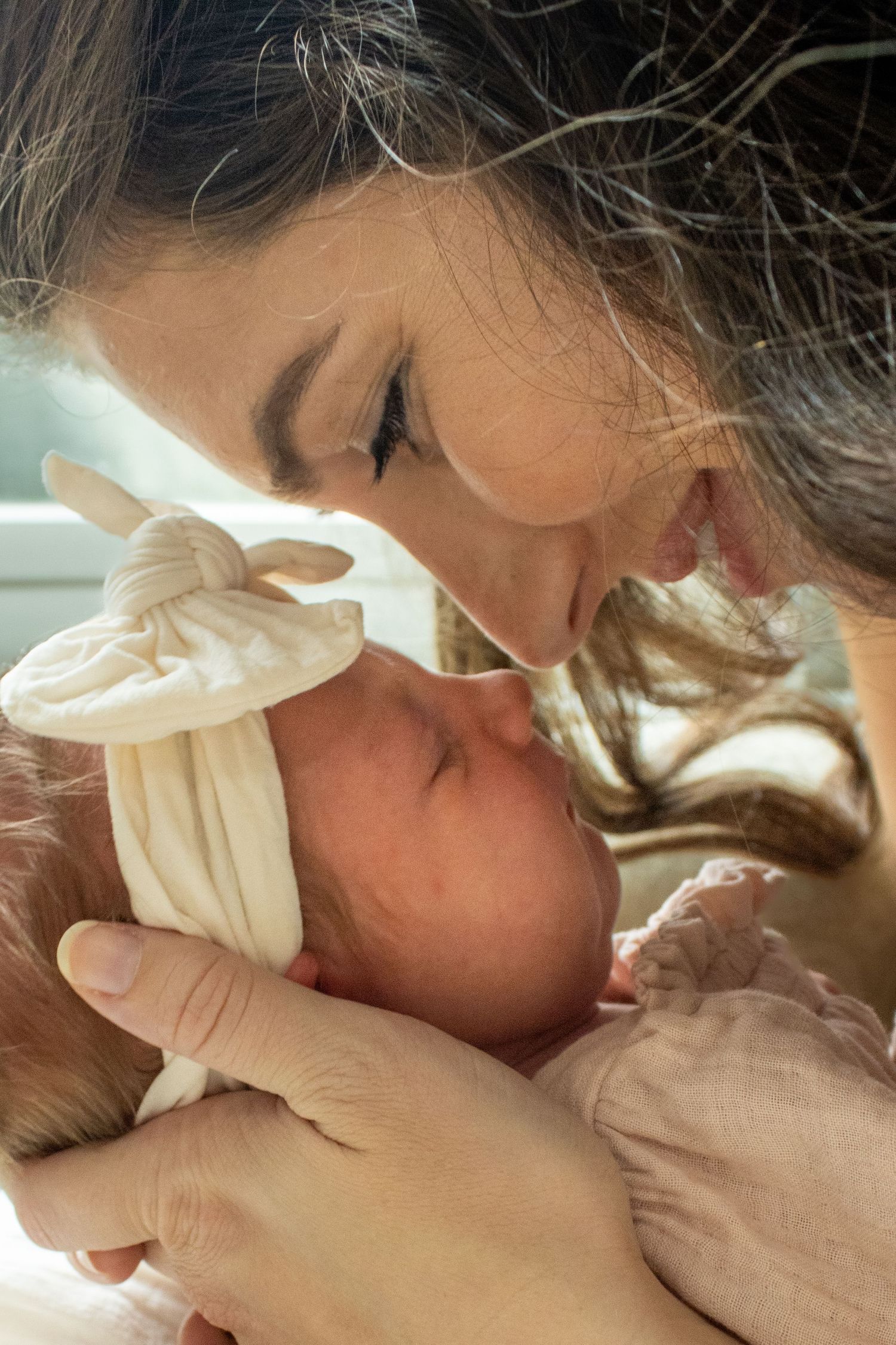 A close intimate moment between a mother and an newborn during Newborn Photography session in Charleston SC.