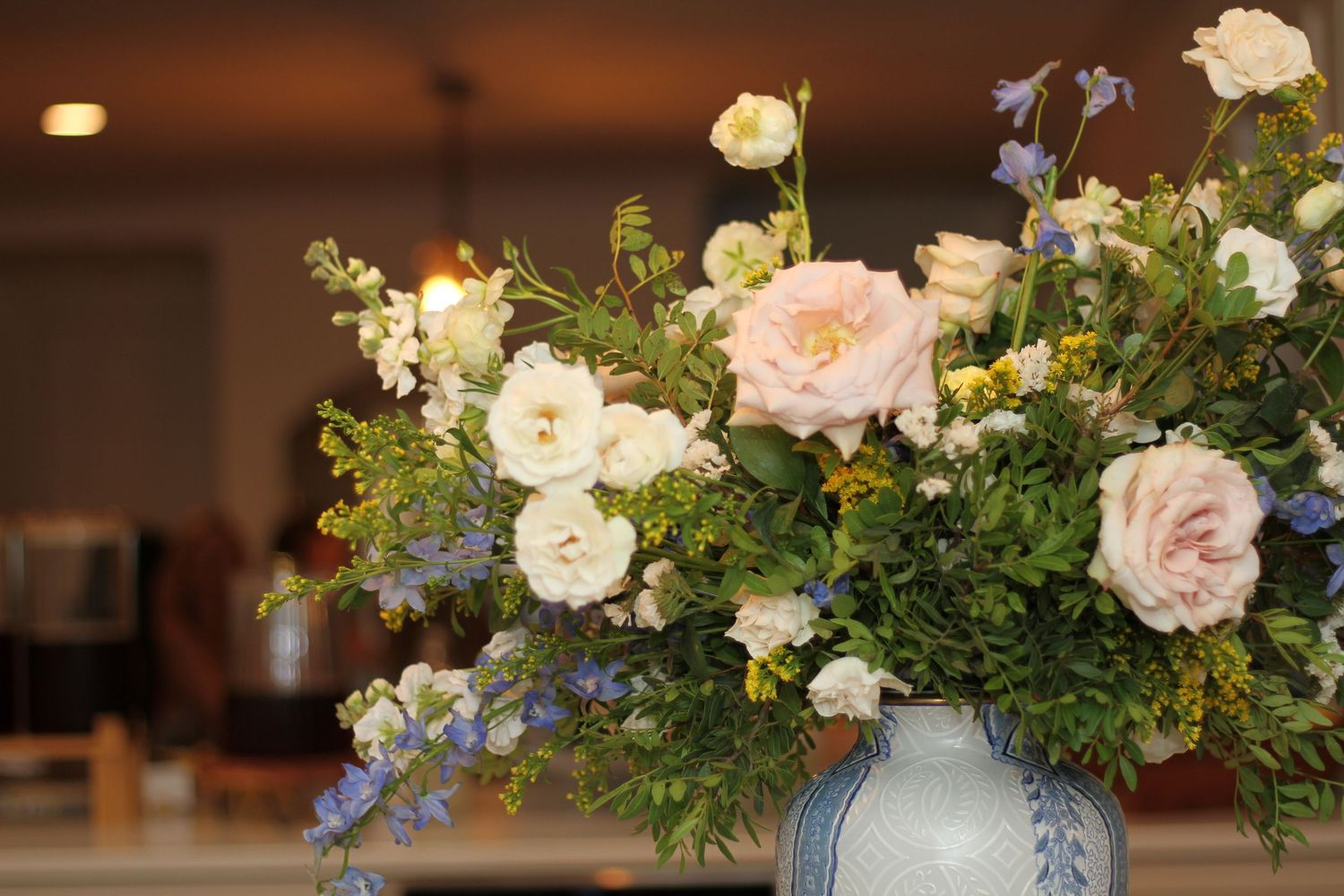 A series of elegant bathroom countertops with floral arrangements, grooming items, and books arranged in a spa-like setting.