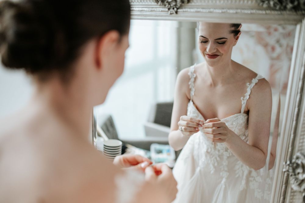 Close-up shots of bridal preparations with vintage mirror and lace details.