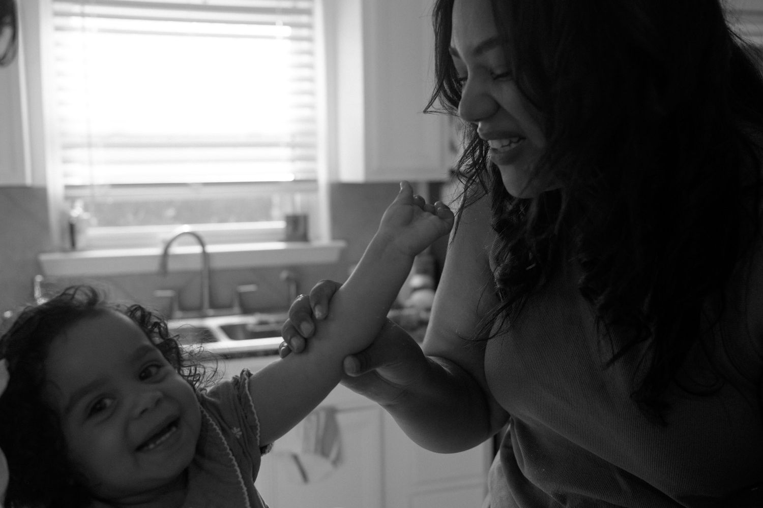 Intimate black and white photographs showing tender moments indoors.
