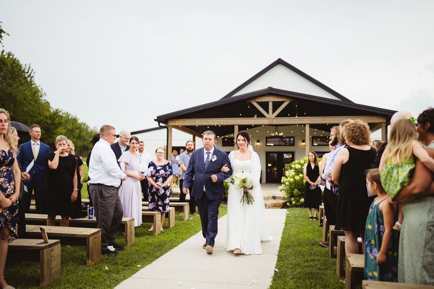 A montage of outdoor wedding ceremony moments at a rustic venue with white gazebo and gathering of guests.