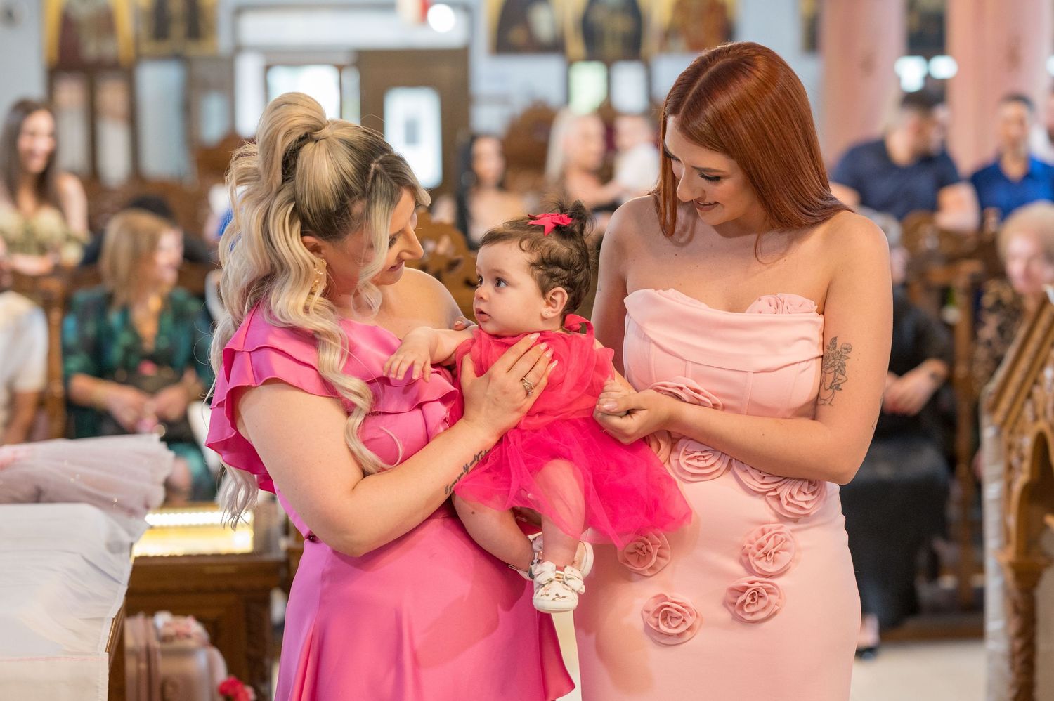 Wedding guests dance and embrace during a joyful celebration in formal attire.