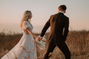 Andrew guides his new wife down the grassy path after they eloped on the Appalachian Trail.