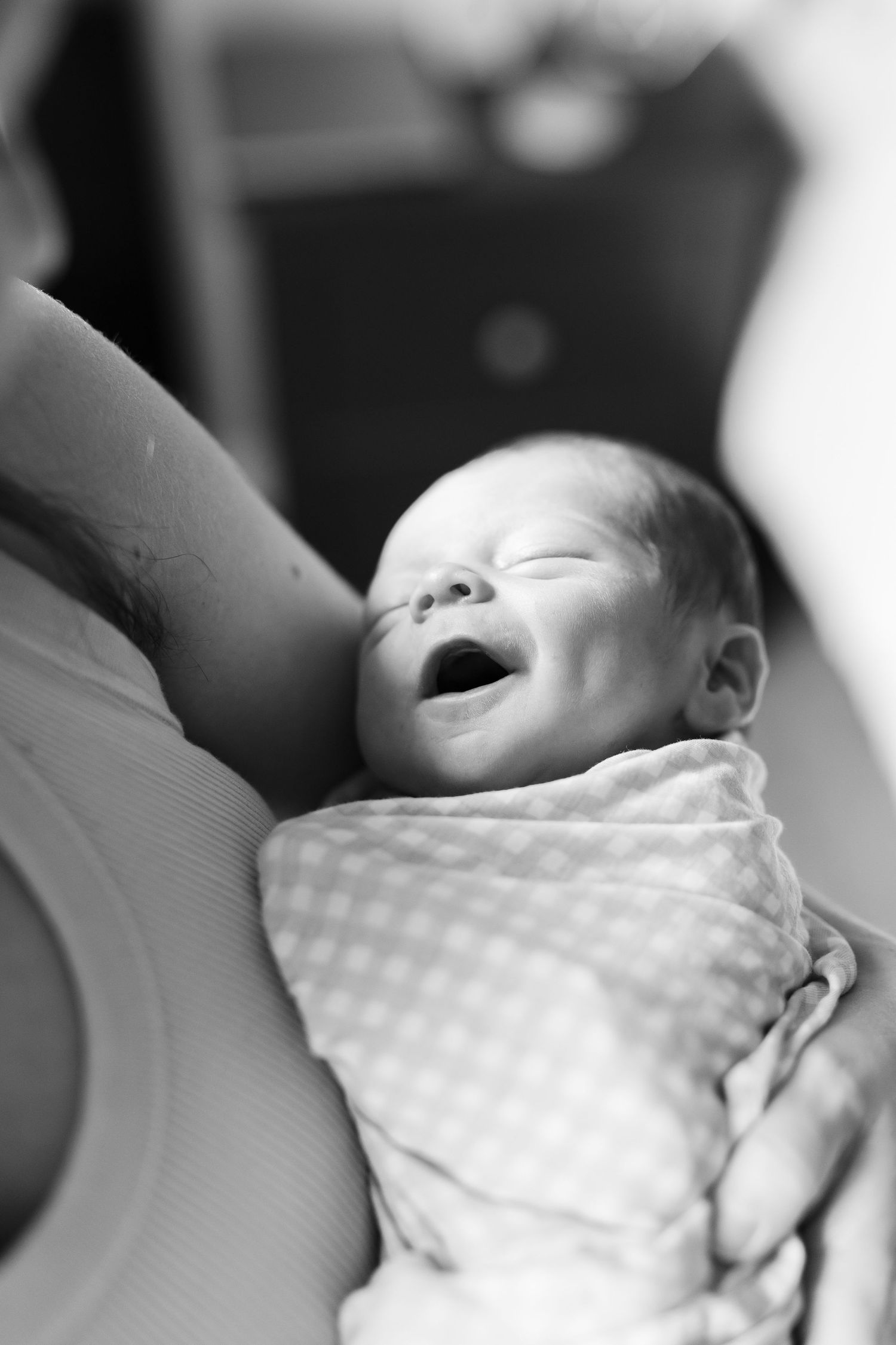 Black and white photo of a sleeping smiling baby