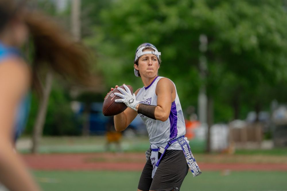 An athlete begins to throw a pass at Pride Bowl hosted by the National Gay Flag Football League
