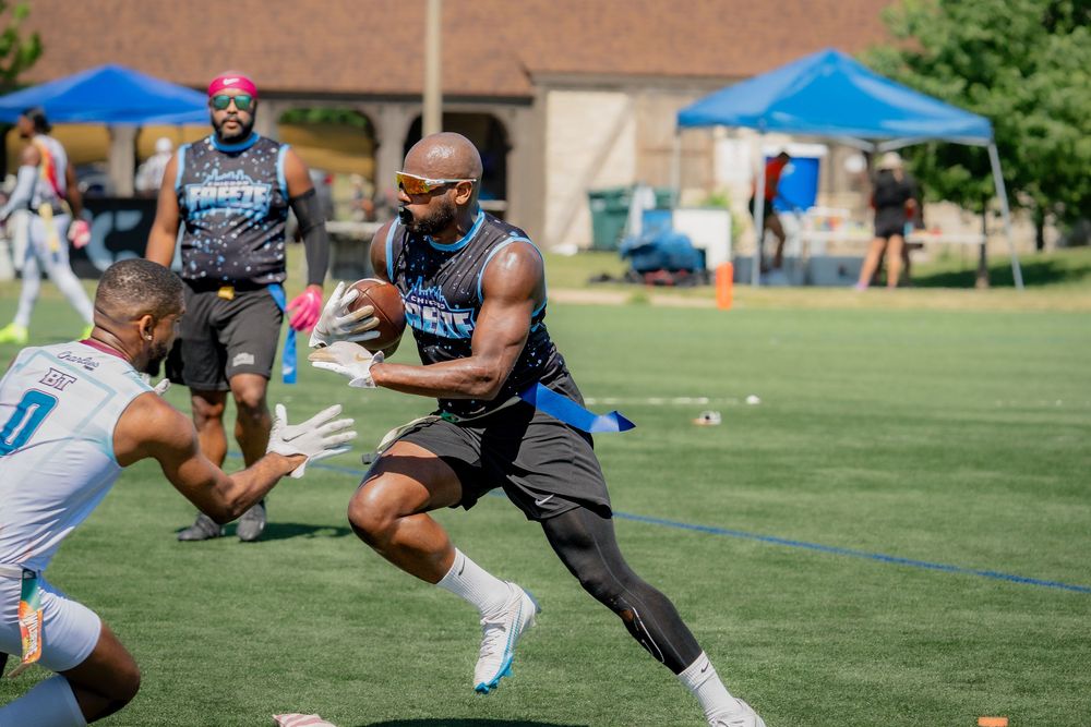 An athlete from the Chicago Freeze moves downfield with the football in hand at Pride Bowl hosted by the National Gay Flag Football League