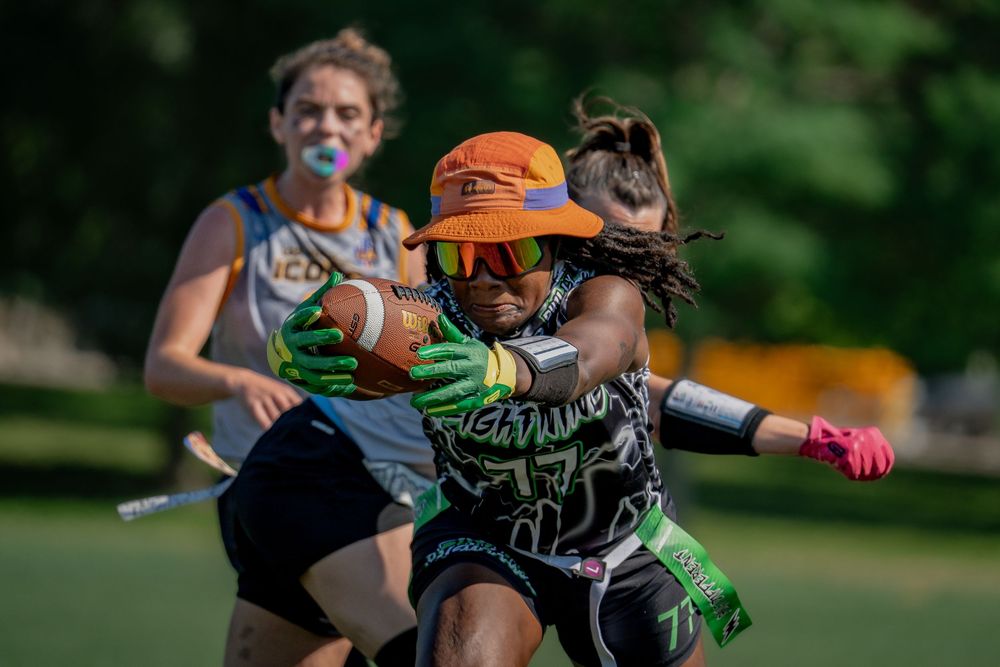 An athlete from the Philly Lightning extends arms to gain yards at Pride Bowl hosted by the National Gay Flag Football League and CMSA