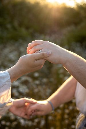 Couple portrait holding hands with each other during golden hour.