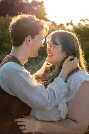 Couple portrait lovingly looking at each other during golden hour.