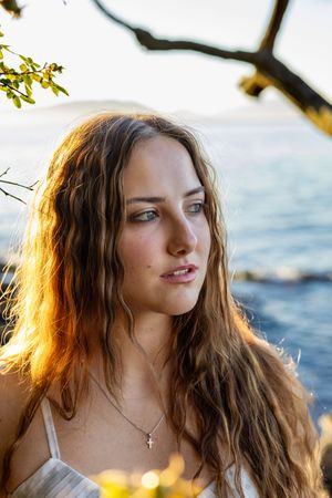 Model headshot portrait in front of the water at sunset at Washington Park in Anacortes, WA.