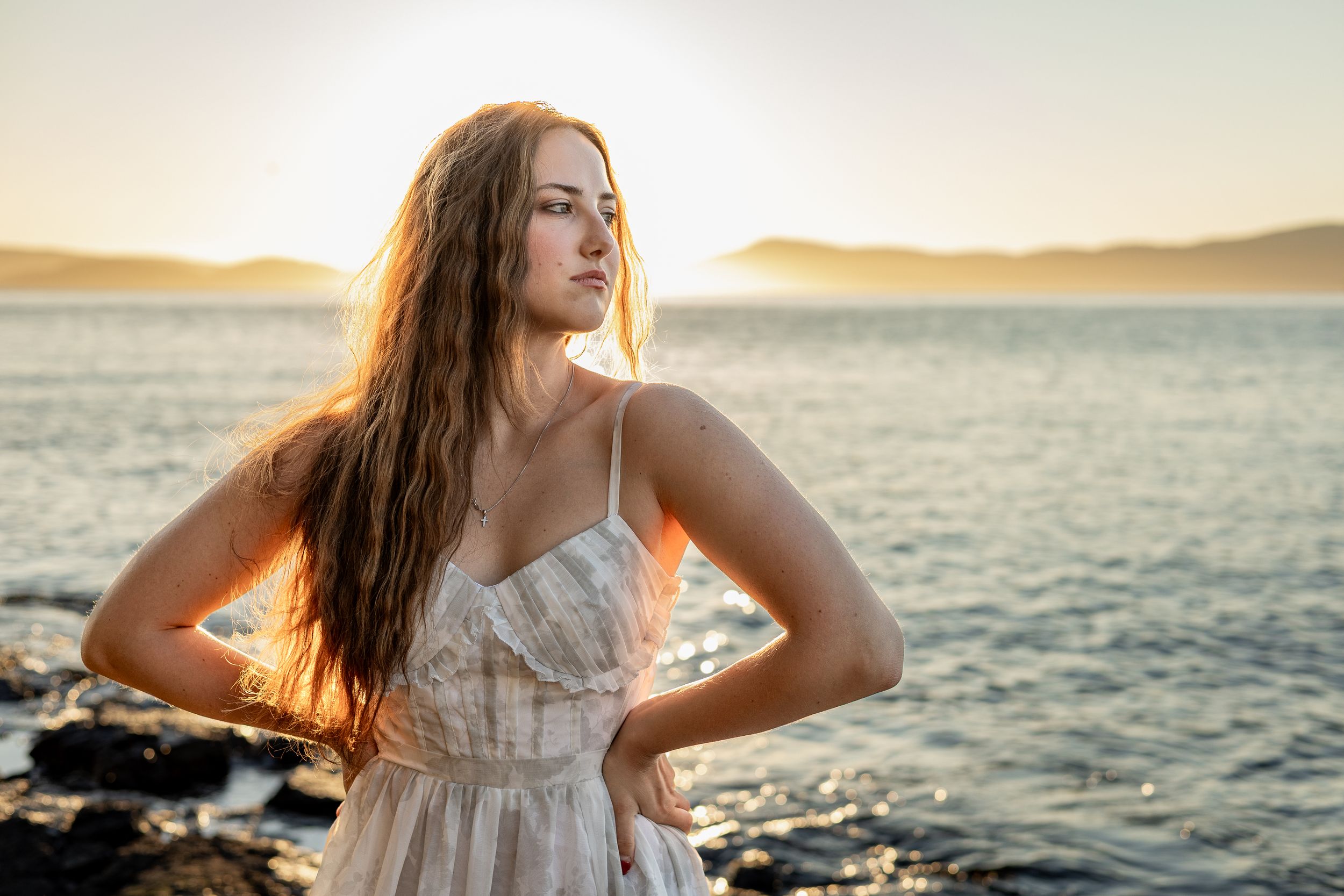 Model posing in front of the water at sunset at Washington Park in Anacortes, WA.