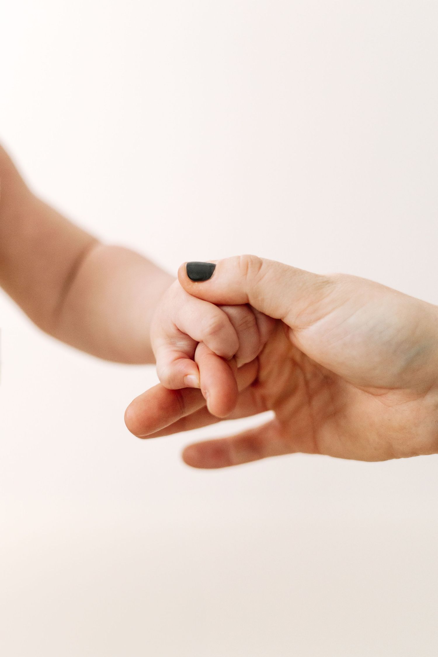 Birthday photography Nottingham baby close up tiny baby hiding mums hand detail shot