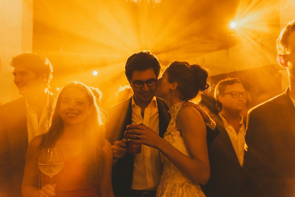 Bride kissing her husband during wedding party in Colombia.