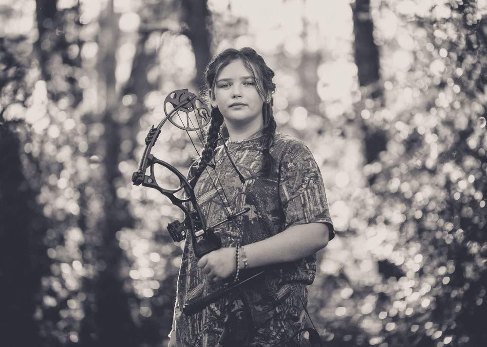 A series of dreamy black and white forest portraits showing a person among trees with soft bokeh lighting effects.