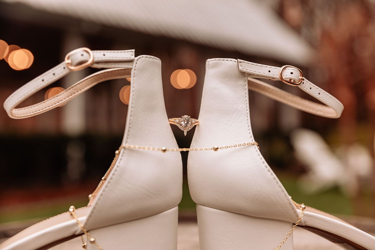 Close-up of elegant bridal shoes arranged symmetrically with soft bokeh lighting.
