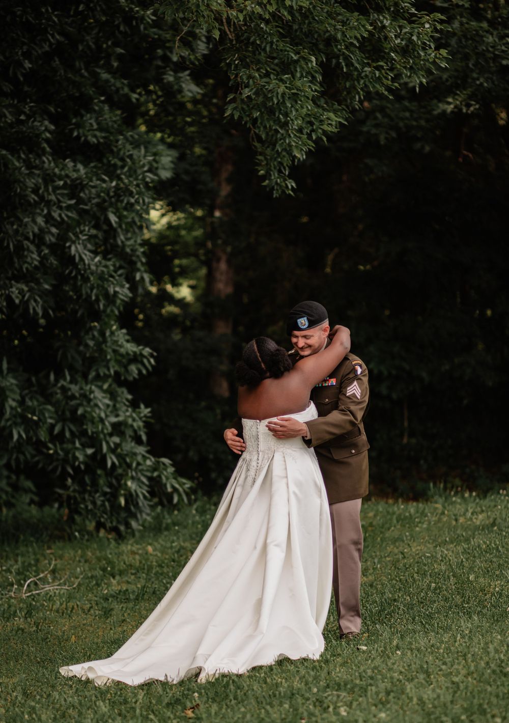 An emotional embrace between a couple during their outdoor wedding photography session.