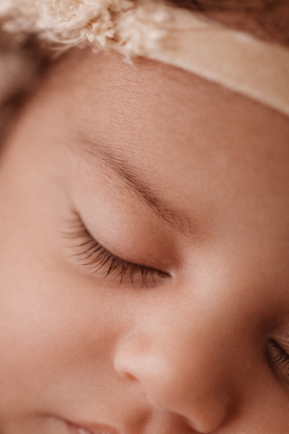 Gentle close-up of closed eyelashes and peaceful expression.