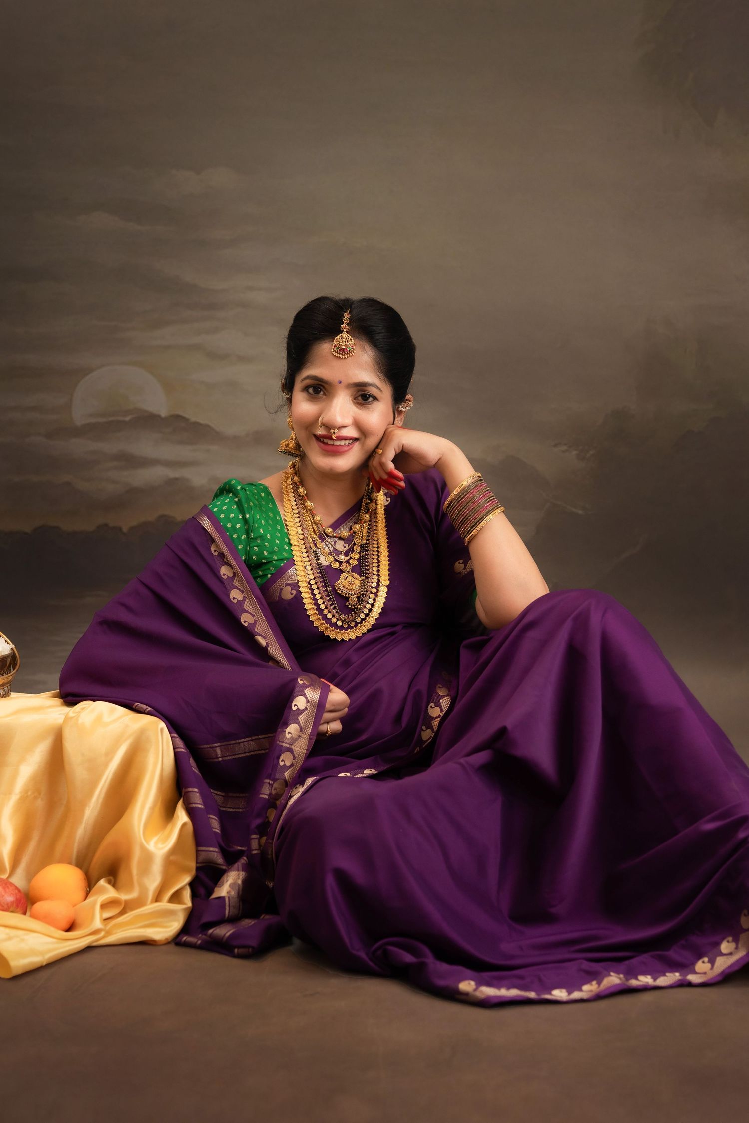 Pregnant woman in traditional South Indian saree posing during studio maternity photoshoot in Hyderabad