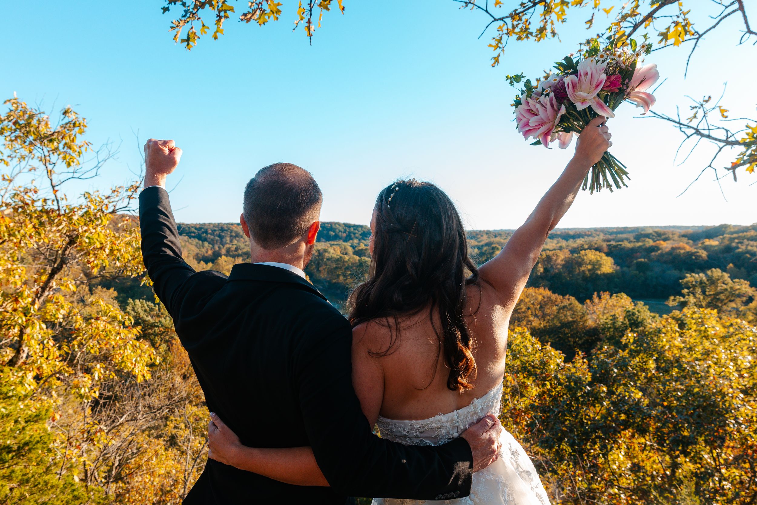 Panoramic wedding shots with couple celebrating against autumn mountain vista.wedding photography st louis