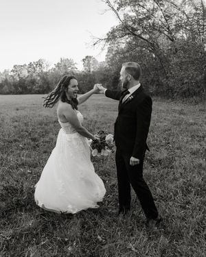 Black and white wedding dance sequence showing couple's playful movements in field.wedding photography st louis