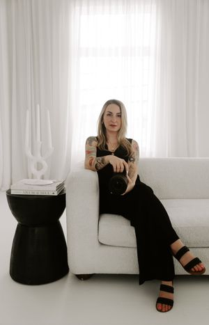 Four minimalist fashion photos showing a person in black attire posing against a white backdrop.