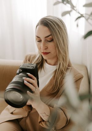 Artistic photography setup with warm tones, indoor plants, and natural window lighting in modern living space.