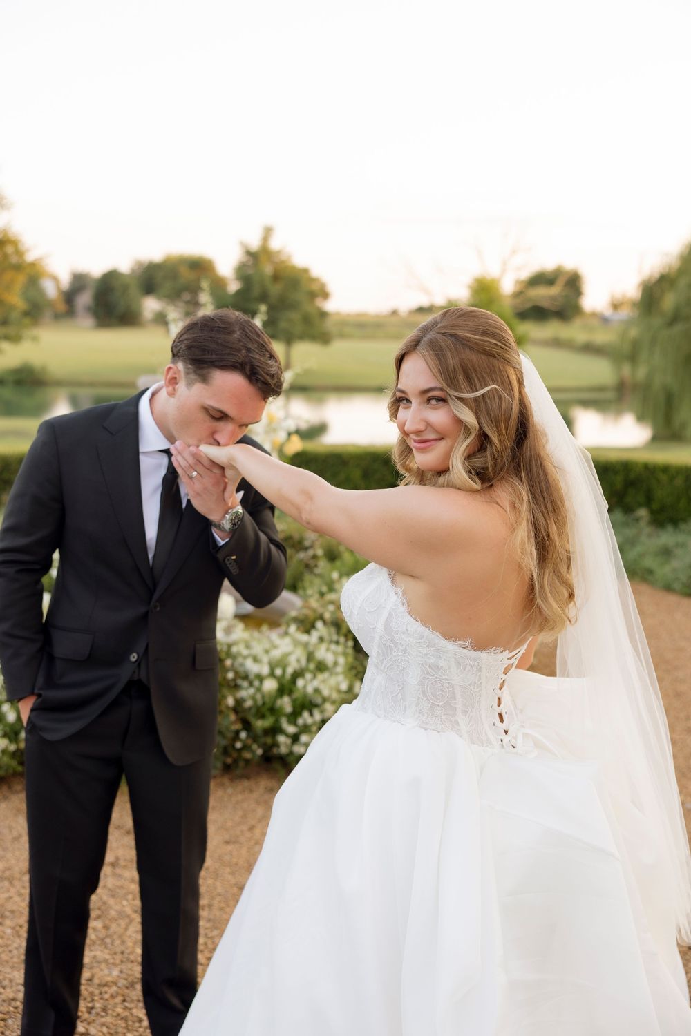 Candid moments between a bride and groom sharing laughter during their sunset wedding photoshoot.