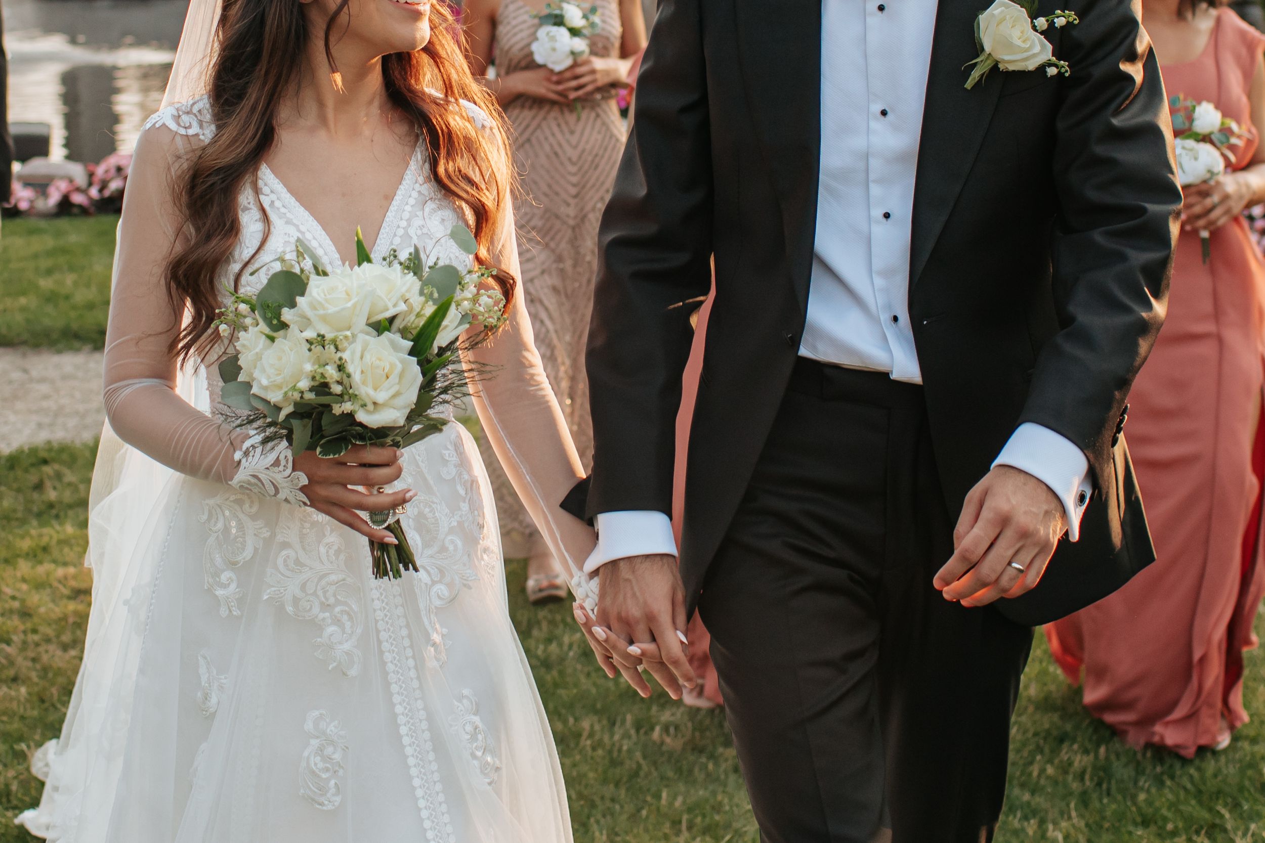 Bride and groom share an intimate moment together during their wedding celebration at an outdoor venue.