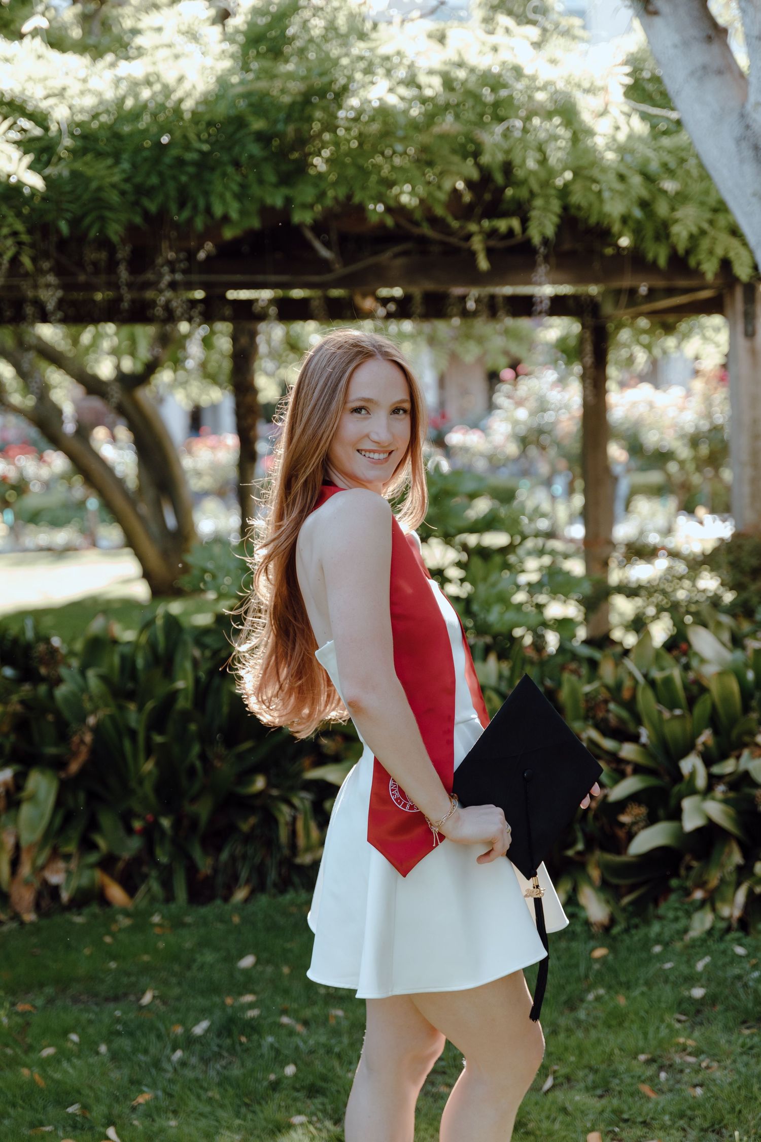 Santa Clara University college graduate poses for their grad photoshoot. Grad photos taken by Bay Area Graduation Photographer.