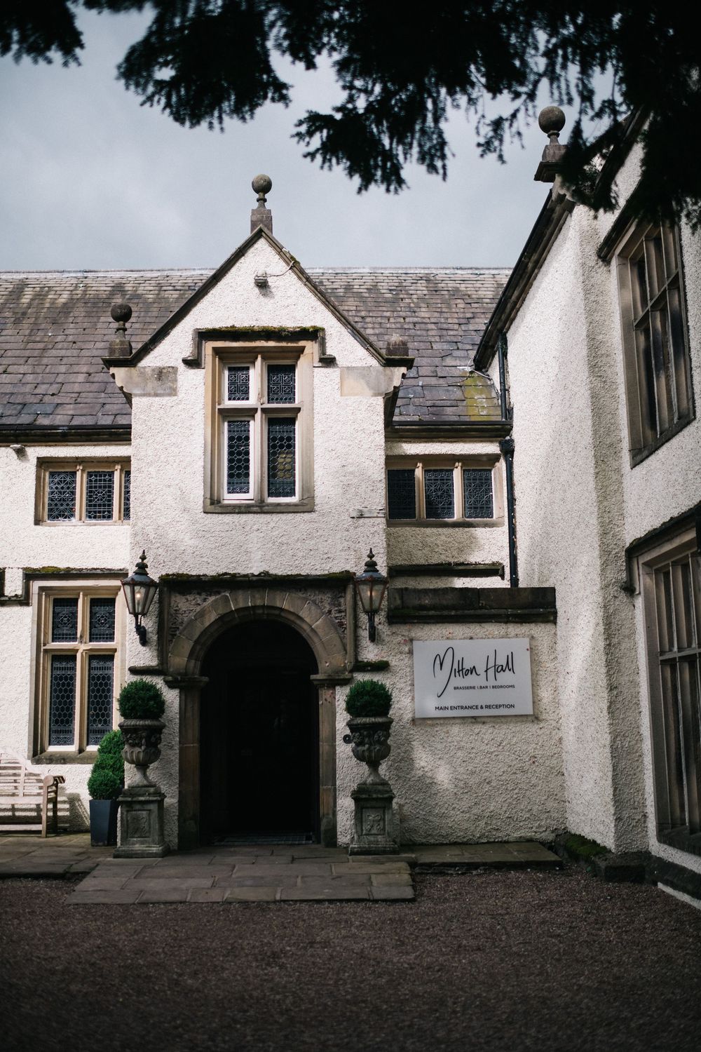 Gothic-style white stone building exterior with arched doorways and traditional architecture.