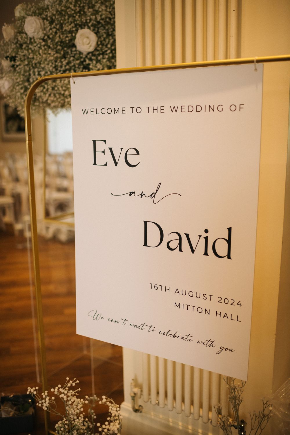 Wedding welcome signs with elegant typography display the couple's names and venue details.